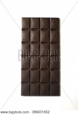 Dark chocolate bar close up on a white background isolated