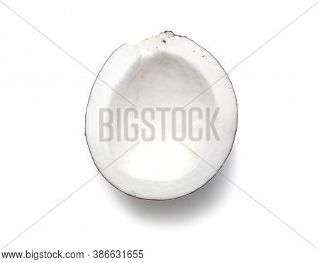 Half a coconut close up on a white background isolated