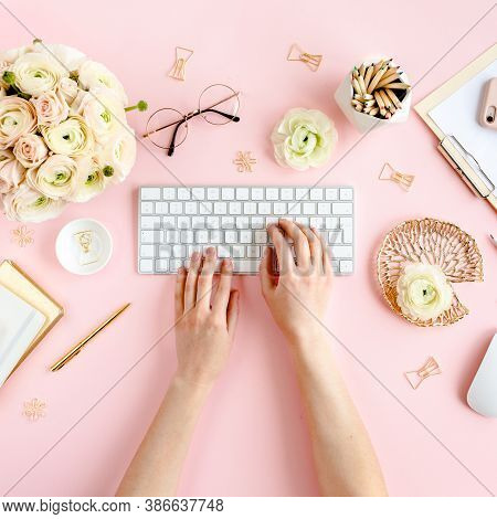 Stylized, Pink Womens Home Office Desk. Workspace With Female Hands, Computer, Bouquet Ranunculus An