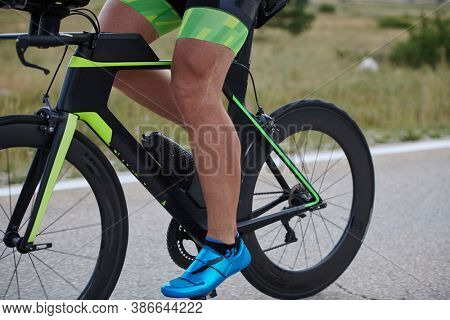 closeu of triathlon athlete riding professional racing bike at workout