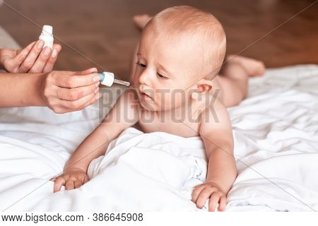 Mother Dripping Nasal Drops For Her Son. Respiratory Syntactical Virus. Health Care Concept,