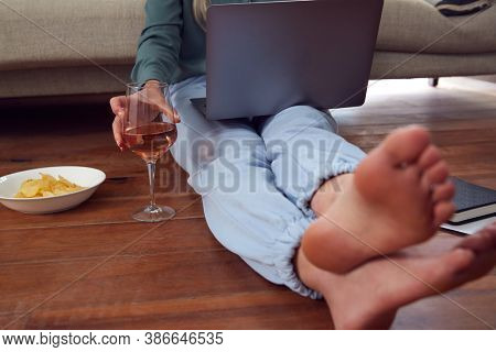 Close Up Of Businesswoman At End Of Day With Wine In Loungewear And Suit On Laptop Working At Home