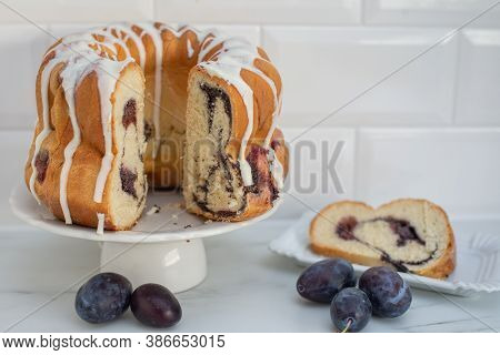 Typical German Poppy Seed Plum Gugelhupf Cake On A Table
