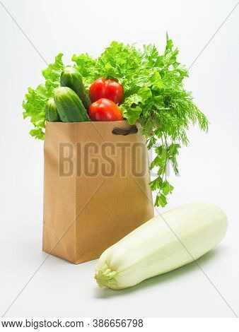 Various Ingredients For Vegetable Salad. Freshly Harvested Greensand Vegetables In A Paper Craft Bag