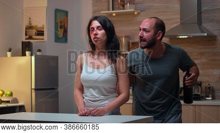 Brutal Drunk Man Screaming At Wife Drinking Alcohol. Traumatised Abused Terrified Beaten Wife Covere