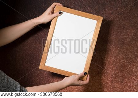 Partial View Of Young Blond Woman Holding Wooden Frame, Dark Background, Mockup, Blank Space