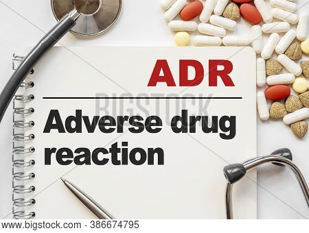 Page In Notebook With Adr Adverse Drug Reaction On White Background With Stethoscope And Group Of Pi