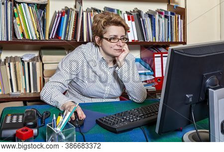 Image Of A Busy Woman Teleworking At Her Desk At The Home. Working At Home Became An Important Recom