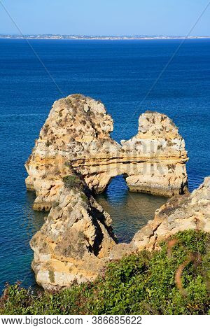 Elevated View Of The Coastline With A Natural Arch In The Ocean, Praia Da Dona Ana, Lagos, Portugal,