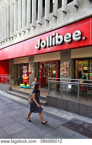Manila, Philippines - November 28, 2017: People Visit Jollibee Fast Food Restaurant In Manila, Phili