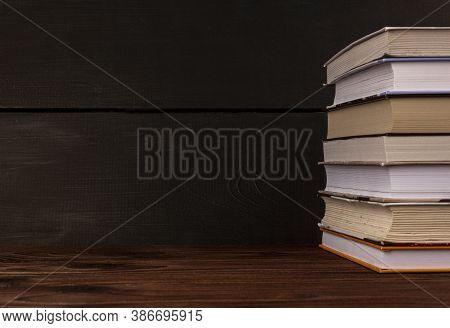 Close-up Stack Of Books On A Wooden Table With Space For Text. Books In The Library On The Table. Li