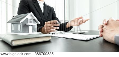 Real Estate Agents With House Models Are Talking To Customers About Renting Houses And Buying Home I