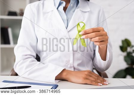 Partial View Of Doctor Holding Green Awareness Ribbon, Mental Health Concept
