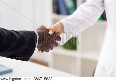 Cropped View Of African American Patient Shaking Hands With Doctor