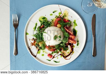 Top View On Gourmet Spanish Buratta Salad With Vegetables And Greens