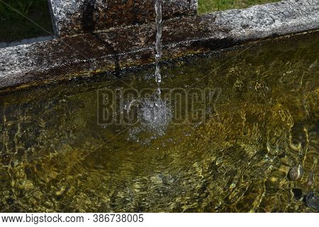 Water Is Flowing In A Fountain In Disentis In Switzerland 8.5.2020