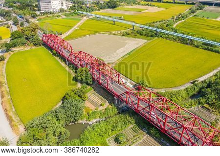 red famous Xilou Bridge over the river and farm in Yunlin county, Taiwan
