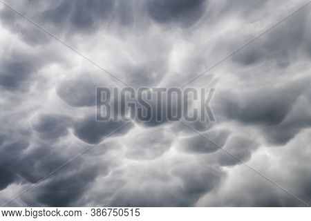 Stormy sky with menacing mammatus clouds before the storm. Climate change nature background