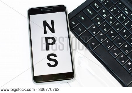 Phone With The Text Nps Net Promoter Score On The Laptop Keyboard. Business Concepts