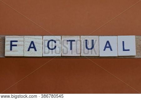Gray Word Factual Made Of Wooden Square Letters On Brown Background