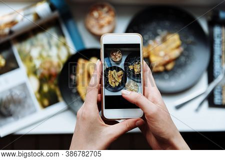 Woman Taking A Photo Of Breakfast With Smartphone, Hands Hold Phone, Frome Above