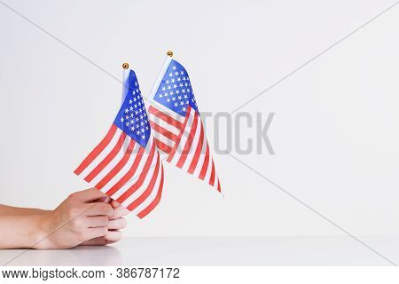 American Flags In Hands On A Light Background Over The Table.stars And Stripes Flag  Setting