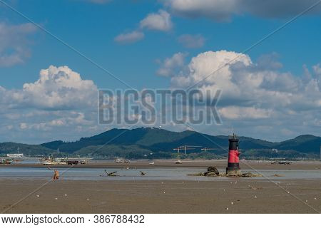 Seosan, South Korea; September 13, 2020: For Editorial Use Only. Red And Black Lighthouse On Muddy T