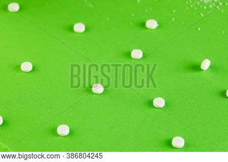 Sugar Substitute Pills And Natural Sweetener In Powder On A Green Podium Texture Background.