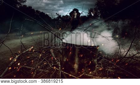 A portrait of an angry witch near the fire cooking spell. Magic, dark force, spell. 