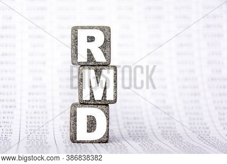 Three Stone Cubes On The Background Of White Financial Statements, Tables With The Word Rmd Required