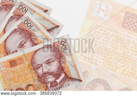 100 Croatian Kuna Bills Lies In Stack On Background Of Big Semi-transparent Banknote. Abstract Busin