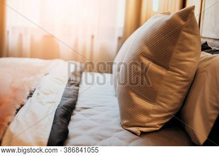 Bed Maid-up With Clean White Pillows And Bed Sheets In Beauty Bedroom. Close-up. Interior Background