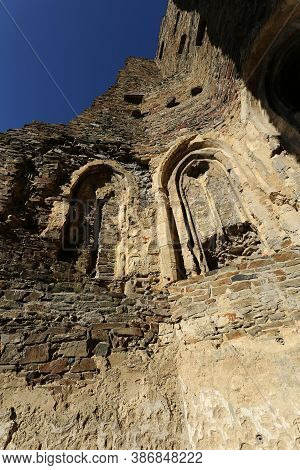 Medieval Castle Walls Details With Restrained Windows And Blue Sky