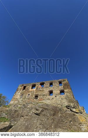 Ruined Frontage Of The Medieval Palace With Deep Blue Sky Above