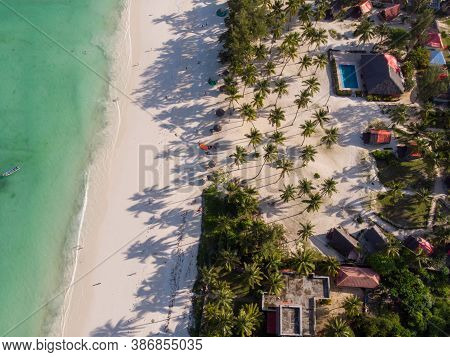 Aerial Shot Of A Luxury Hotel On A Beach First Line With Palm Trees Garden At Evening Time In Paje V