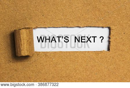 The Text What Next Behind Torn Brown Paper