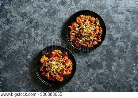 Spicy Garlic Fried Chicken (kkanpunggi). Asian Chicken In Sweet And Sour Sauce On Plate Over Dark St