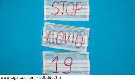 Typical 3-ply White Surgical Mask With Rubber Earhooks To Cover Mouth And Nose With English Block Le