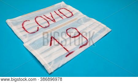 Typical White 3-ply Surgical Mask With Rubber Earhooks To Cover Mouth And Nose With English Block Le