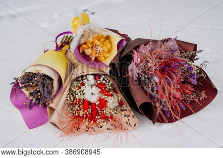 Beautiful Bouquets Of Dried Plants In Various Package On White Snow