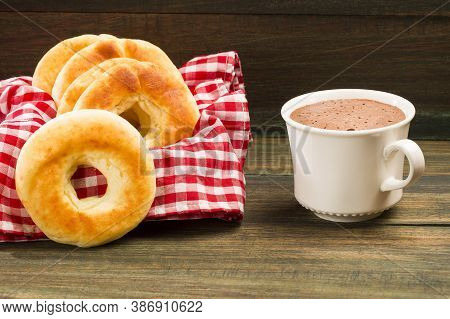 Pandequeso Traditional Colombian Food - Hot Drink Chocolate. Wood Background