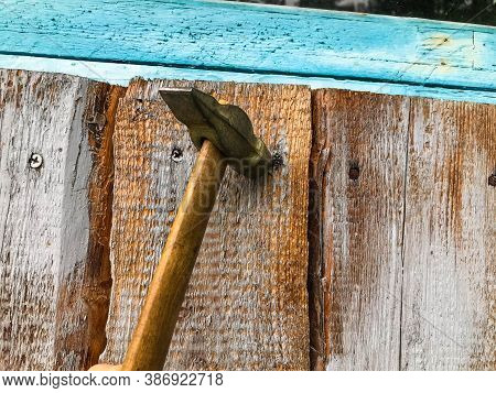 Hammer On A Wooden Handle With A Metal End. Hammer Nails On A Wooden Surface. Metal Nails Are Driven
