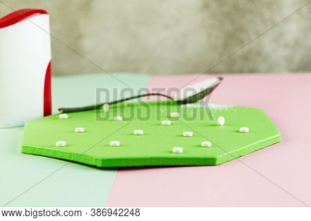 Sugar Substitute Tablets And Natural Sweetener Powder On A Green Podium. Copy Space For Text.