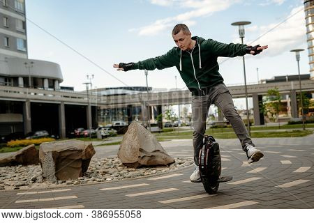 Man Riding Electric Mono Cycle On Street, Aerobatics, Figure