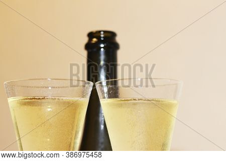 Bottle Of Shampagne And A Two Glasses Of Cold Shampagne Before Drinking On The White Background