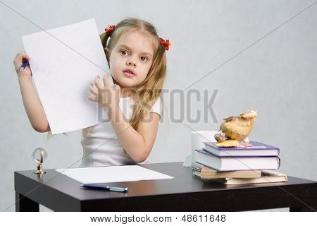 Girl shows sheet of paper with scribbled notes, sitting at the table in the image of the writer