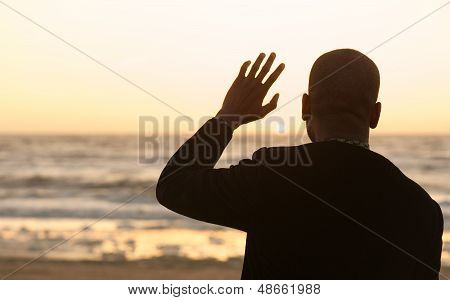 Man Waving At The Sunset