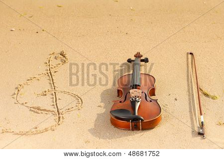 Violin And G Clef On Beach. Music Concept