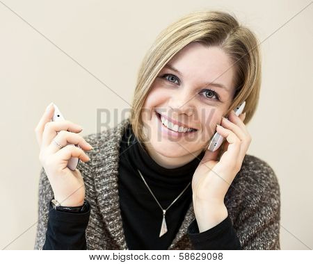Happy Woman Calling With Two Mobile Phones