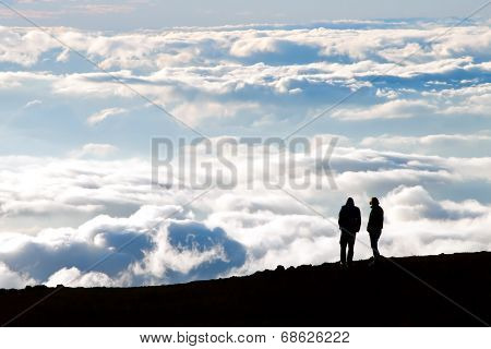 Tourist Silhouette Watching Sunset On The Top Of  Haleakala Volcano On Maui Hawaii